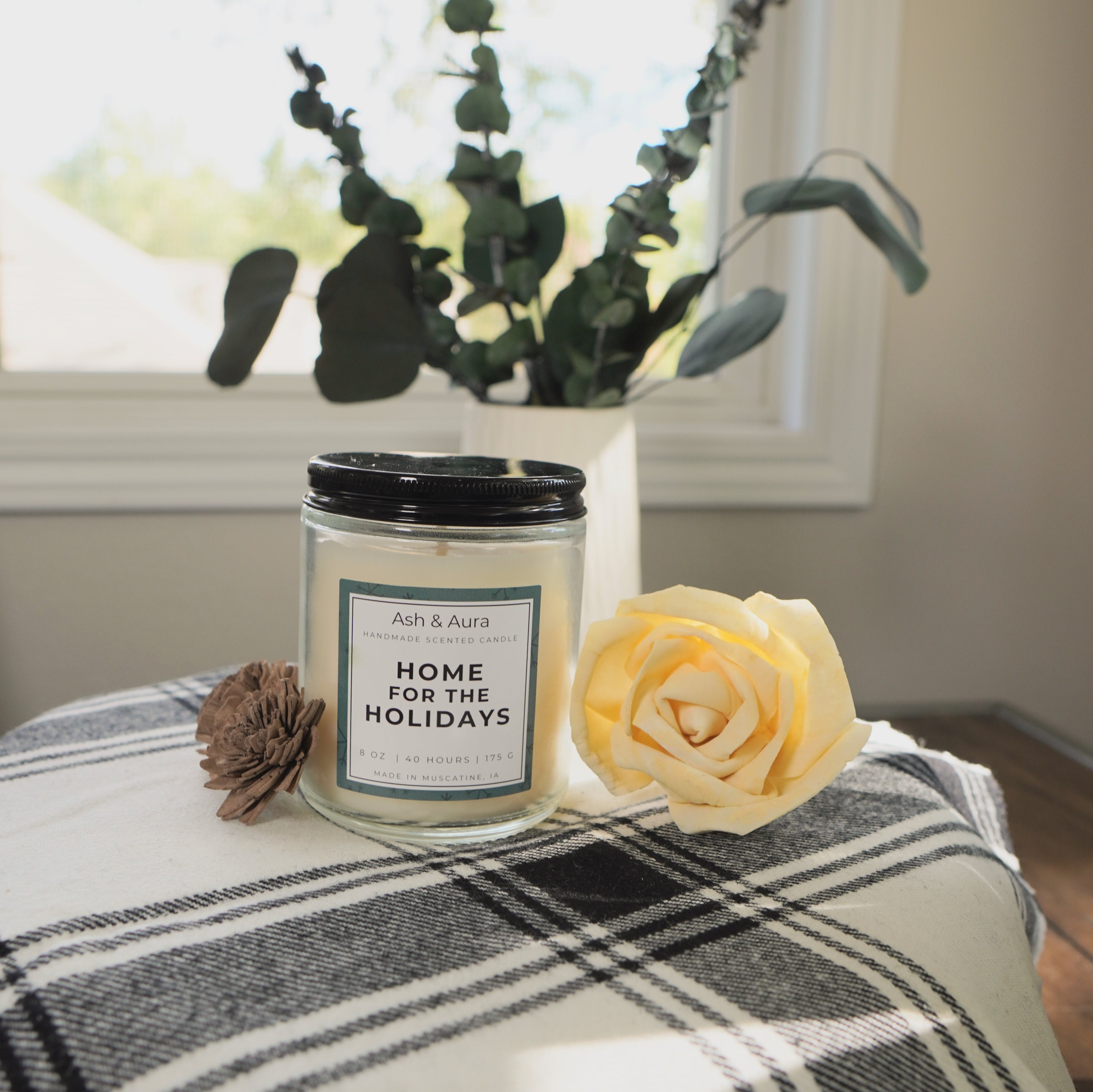 A close-up of the unlit Home for the Holidays candle.